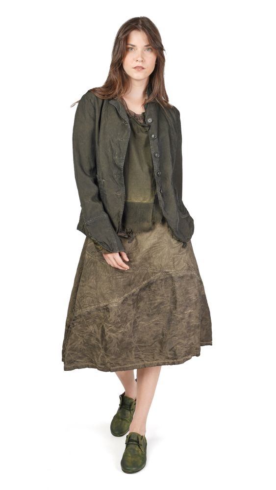 Frau trägt olivgrünen oversize-Jackett, langes Kleid und grüne Blockabsätze.