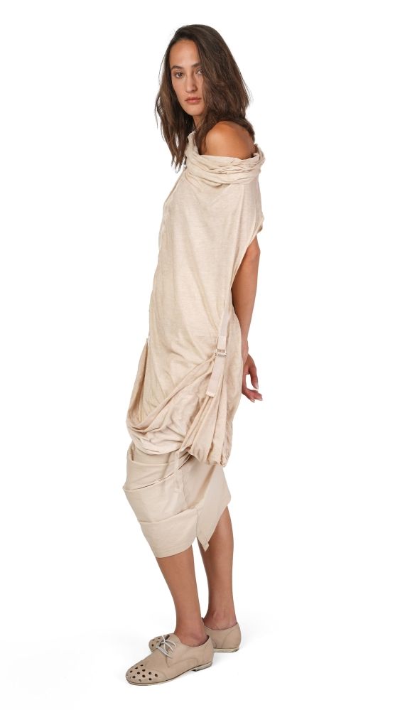 Frau trägt beiges, offenes Wickelkleid mit Sandalen, elegant und locker.
